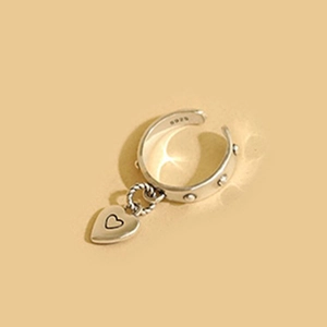 Close-up of S925 silver open ring showing heart pendant and hallmark engraving
