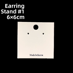 Detailed view of 6x6cm white paper jewelry cards for ear studs with Made in Korea text