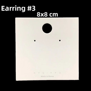 Detail view of 8x8cm white jewelry display card with pre-cut holes for earrings and studs