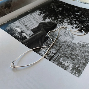 Elegant 925 sterling silver snake chain necklace displayed on a fashion magazine background