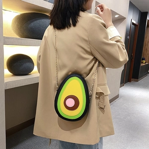 Cute avocado shaped PU leather crossbody bag with gold chain strap worn by a model