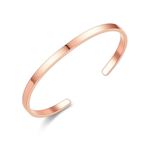 Detail view of rose gold C-shaped stainless steel bracelet with brushed metal texture