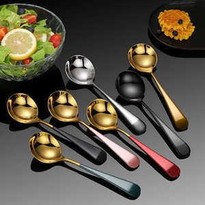 Macro shot of colorful stainless steel round spoons in gold, silver, black, and rose finishes