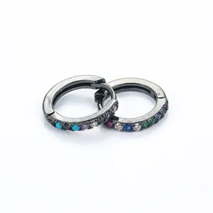 Macro shot of gunblack huggie earrings featuring multi-colored micro-pave zircons