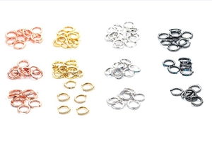Macro view showing diverse micro-set zircon hoop earrings in gold, silver, and rose gold