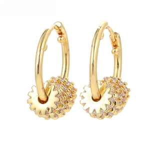 Detailed macro of gold gear hoops featuring micro-paved white zircon stones