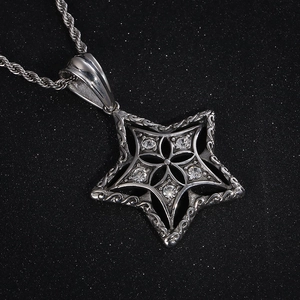 Macro detail of gothic star pendant featuring five inset crystals on a silver twist chain