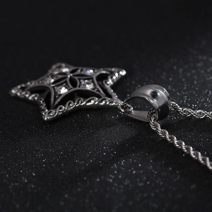 Macro shot of silver star pendant with clear stones and twisted rope chain