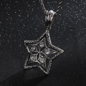 Macro shot of silver star pendant with cubic zirconia stones on twisted chain
