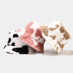 Winter plush bucket hat with stylish cow print in black, pink, and brown variations
