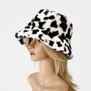 Detail of plush faux fur cow print bucket hat showing soft thick texture and pattern