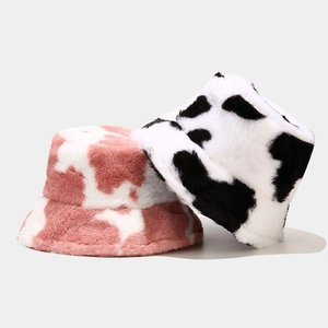Winter faux fur bucket hats with cow print in black-white and pink-white colorways