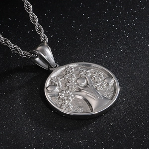 Detailed macro shot of silver Tree of Life pendant with textured twist chain necklace