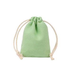 Detail of light green drawstring pouch showing natural cotton canvas texture on white background