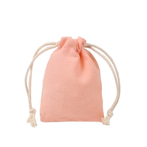 Detailed view of pink canvas drawstring gift bag with woven cotton texture and cords