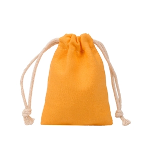 Detail of a bright orange-yellow canvas drawstring gift bag with a thick white cotton cord
