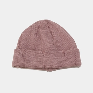 Detail of distressed knit texture and ripped holes on a pink street-style beanie hat