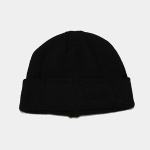 Detail of classic black cuffed beanie showing fine ribbed knit texture and material