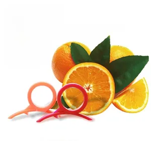 Creative ring-style orange peeler tool shown in orange and red for easy citrus peeling