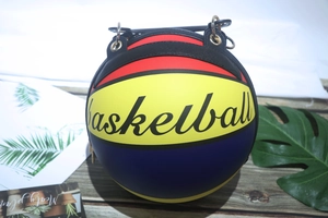Detail view of colorful basketball bag on wooden surface with gold chain attachments