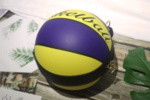 Detail of creative basketball-shaped crossbody bag with graffiti and litchi texture PU leather