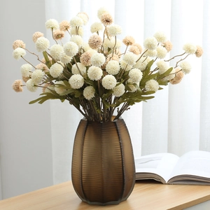 Faux dandelion and pompom chrysanthemum bouquet in vertical striped glass vase for home decor