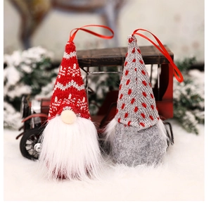 Detail of knitted Swedish gnome ornaments with faux fur beards on a winter backdrop