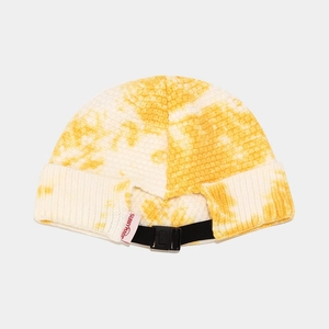 Detail of yellow and white tie-dye knit docker hat with adjustable black plastic buckle strap