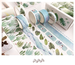 Close-up of decorative washi tape set featuring cactus, waves, and tropical leaf patterns