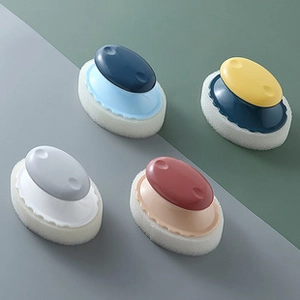 Close-up of ergonomic cleaning sponge brushes in four assorted color combinations
