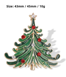 Detailed view of a green enamel Christmas tree brooch with red rhinestones and measurements
