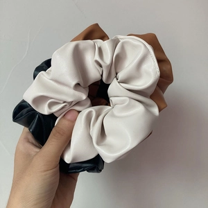 Set of 3 minimalist PU leather scrunchies in milk tea cream, brown, and black tones