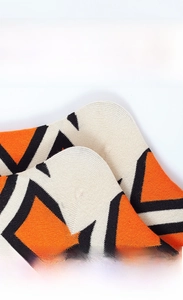 Detail of geometric knit socks showing reinforced heel and smooth toe seam for comfort