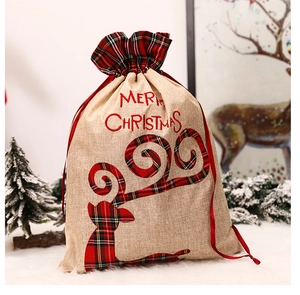 Close-up of burlap Christmas gift bag with plaid trim and Merry Christmas embroidery