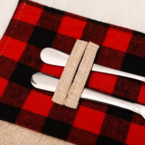 Red and black buffalo plaid Christmas utensil holder with burlap and stainless steel