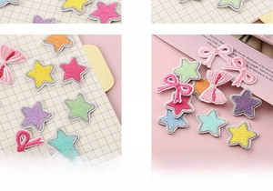 Macro detail of colorful embroidered star and bow patches with adhesive backing