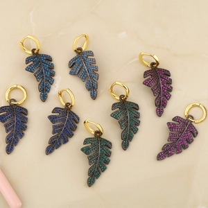 Detail of leaf earrings with gold finish and vibrant micro-pave colored crystals