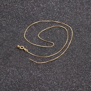 Detail view of the elegant gold box chain necklace featuring a secure spring clasp