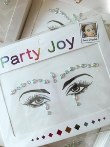 Close-up of holographic face crystal stickers for makeup with colorful rhinestone patterns