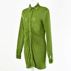 Detail of green long sleeve shirt dress featuring front ruched design and button closure