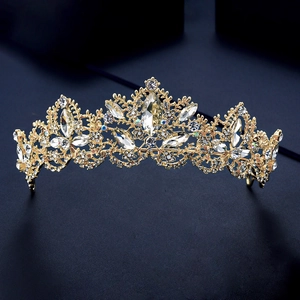 Close-up of golden bridal crown with sparkling crystals on dark blue textured background