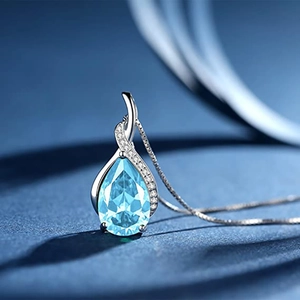Close-up of teardrop-shaped aquamarine pendant necklace with cubic zirconia details