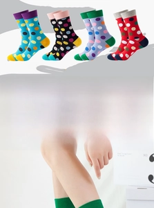 Detailed view of colorful polka dot cotton crew socks in green, purple, red, and black