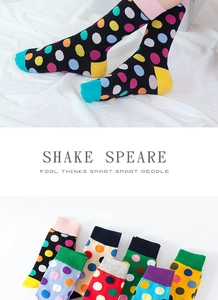 Detailed view of colorful polka dot mid-calf knit socks in various vibrant colorways