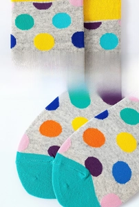 Detailed close-up of elastic ribbed cuff and reinforced toe on colorful polka dot socks