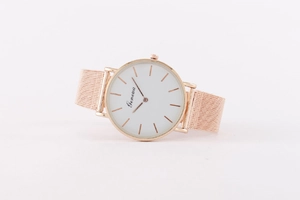 Close-up of rose gold Milanese mesh strap and white minimalist watch dial by Geneva