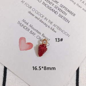 Macro shot of 16.5x8mm red strawberry charm pendant with gold hoop for DIY jewelry