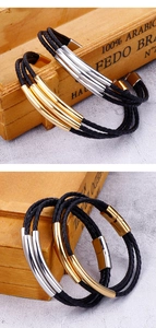 Detail of multi-layer braided leather bracelet with gold and silver metal tube accents