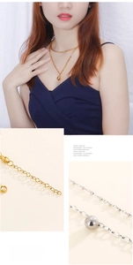 Detail view of double layer necklaces featuring metallic ball pendants in gold and silver finish