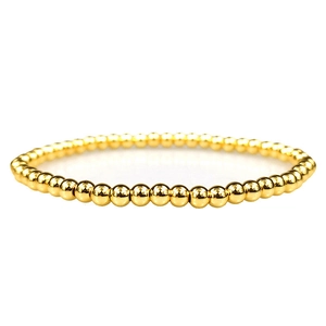 Detailed view of polished 18K gold-plated copper beads on a minimalist bead bracelet